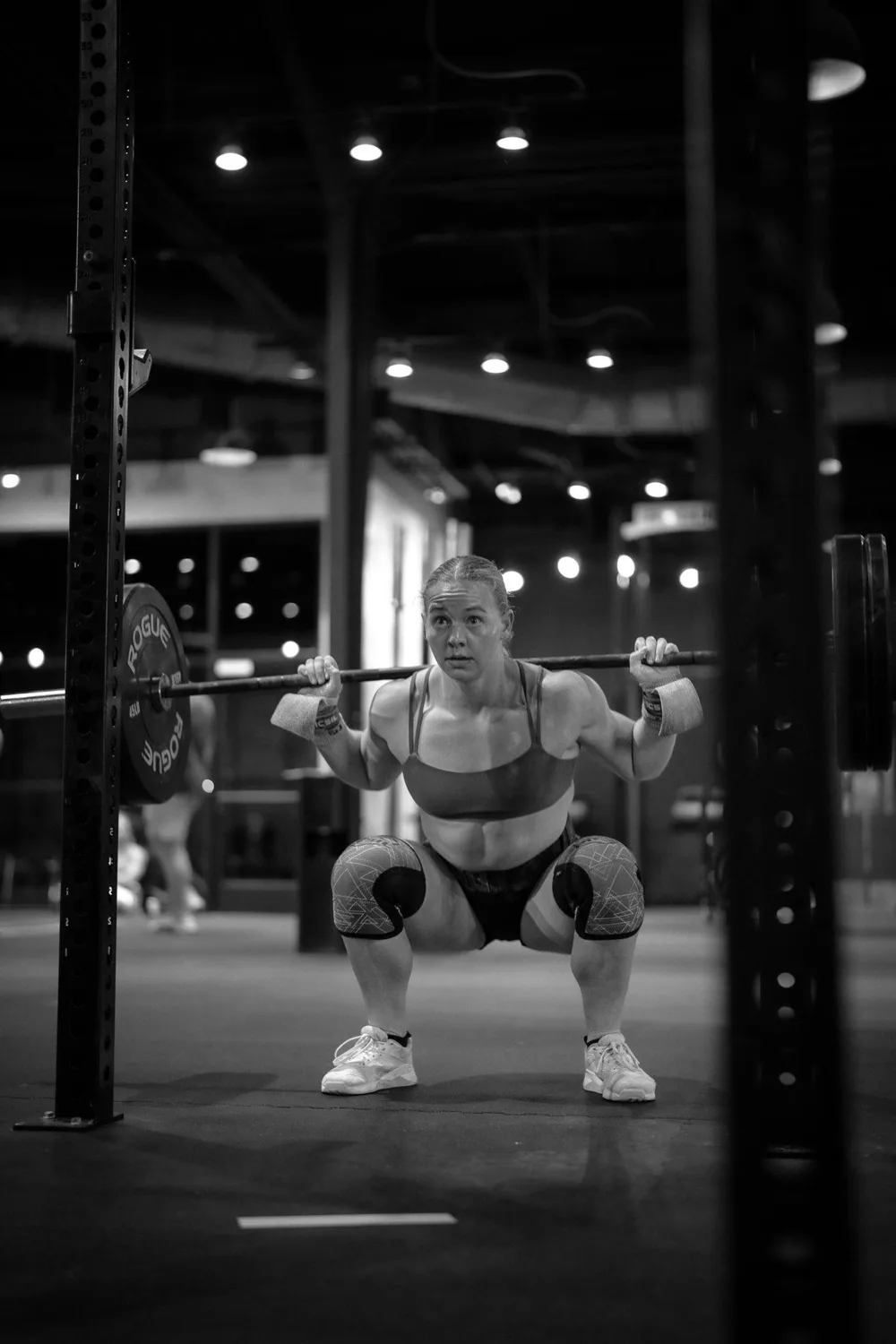Focused strength practice with a barbell in a black and white training photograph