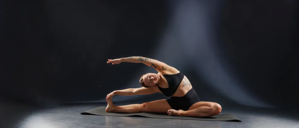 A controlled seated side bend with arms extended