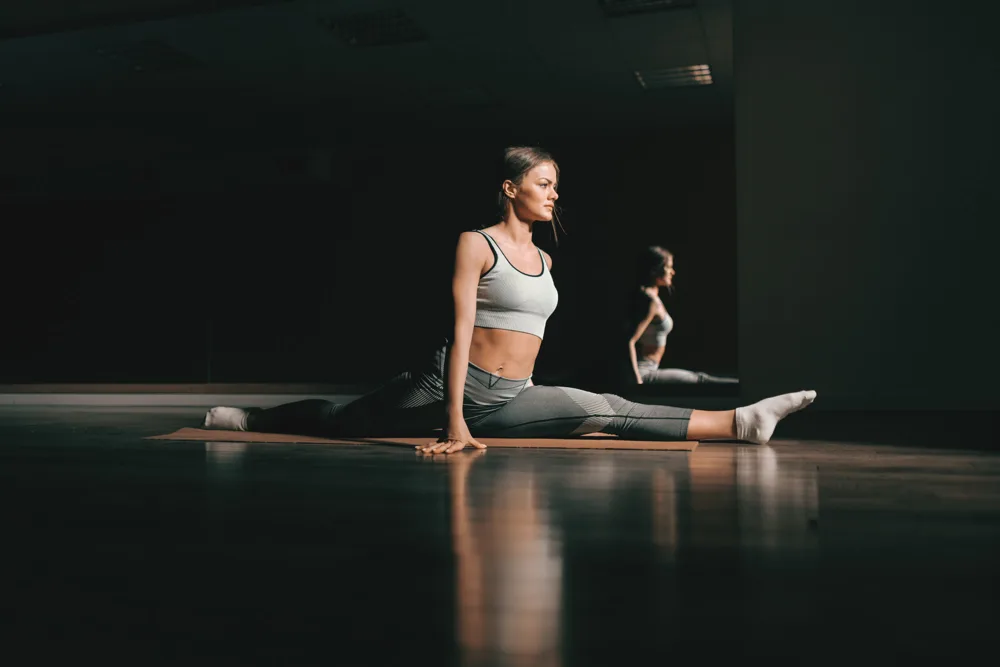 An unhurried seated movement practice in a softly lit training space