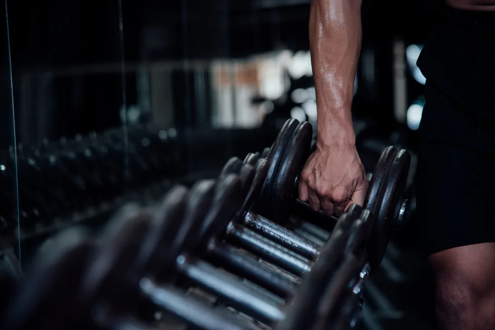 Selecting a dumbbell from the weight rack